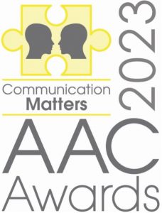 The AAC Awards Logo includes the Communication Matters logo. There are two heads facing each other inside a yellow jigsaw puzzle piece. This shows communication is a two-way process and the jigsaw piece represents AAC solving and supporting where barriers to communication exist. 
The logo includes the text: AAC Awards 2023.
