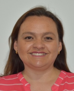 a woman with long brown hair, smiling