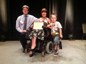 Lisa Lehmann, Words+/ ISAAC Outstanding Consumer Lecture Award winner, with son Hunter and Jeff Dahlen of Words+, Inc.